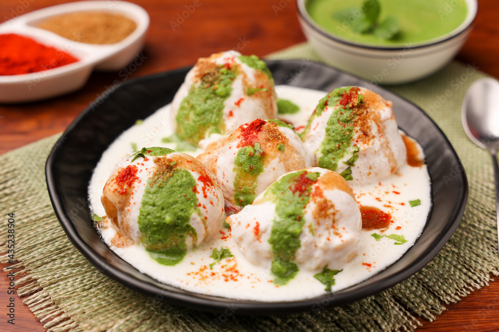Indian street food Dahi vada Dahi Bhalla with green chutney, tamarind