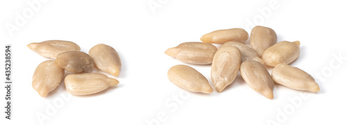 close up of peeled sunflower seeds, isolated on white background photo