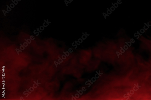 Close-up of red smoke with spray from a humidifier. Isolated on black background