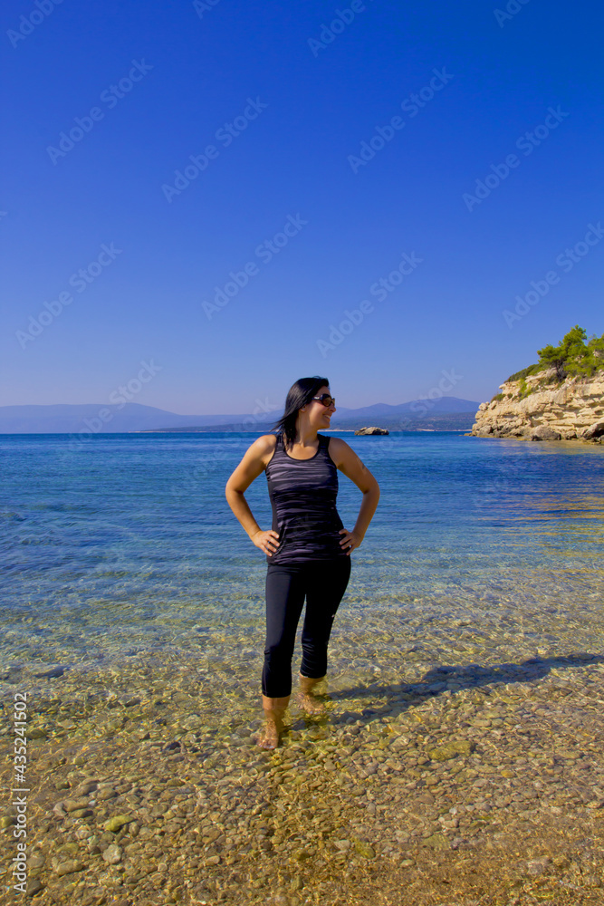 happy young woman in sunglasses on the beach happy young woman in sunglasses on the beach