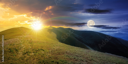 day and night time change concept above mountain landscape in summer. grassy meadows on the hills rolling in to the distant peak beneath sky with sun and moon