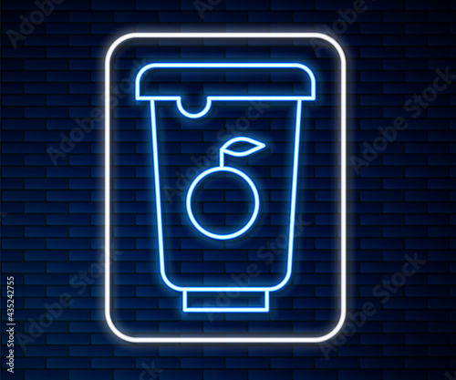 Glowing neon line Yogurt container icon isolated on brick wall background. Yogurt in plastic cup. Vector