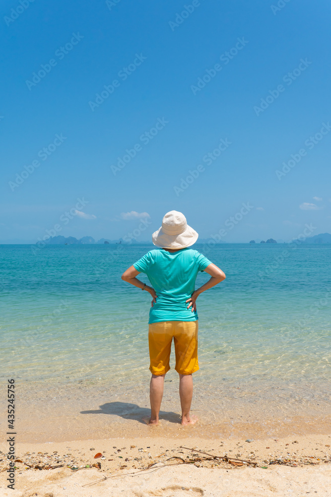 rear view portrait of senior woman enjoy white beach and blue sea of tropical island during summer vacation rear view portrait of senior woman enjoy white beach and blue sea of tropical island during summer vacation