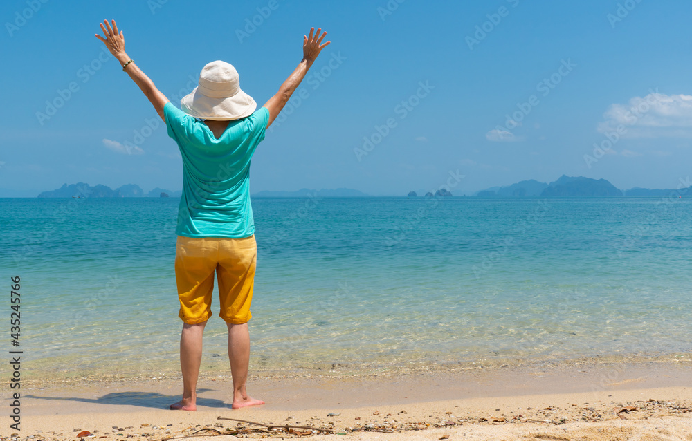 rear view portrait of senior woman enjoy white beach and blue sea of tropical island during summer vacation rear view portrait of senior woman enjoy white beach and blue sea of tropical island during summer vacation