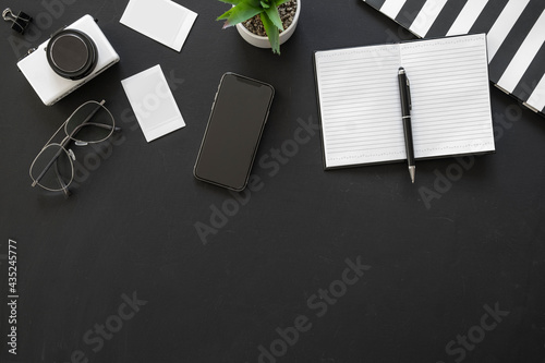 Office black workspace with office supplies and copy space on black background, flat lay