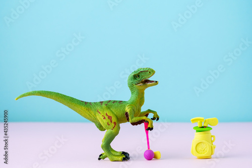 Cute little dinosaur playing golf. Humor card for the day of golf lovers. © dvulikaia