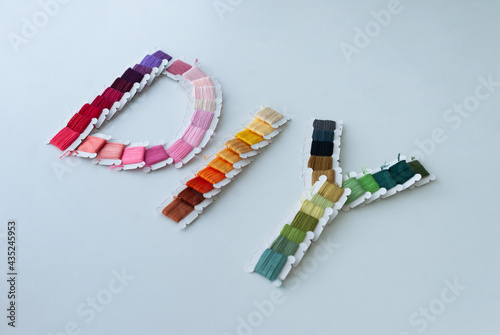 Obraz na płótnie Word DIY world made of colorful bobbins, treads. Do it yourself concept. Sewing, hobby w salonie