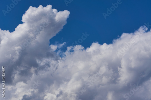 Cumulus white clouds on the blue sky