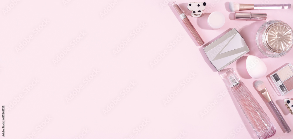Beauty flat lay with cosmetic fashion makeup accessories on pink background. Top view. Flat lay, banner.