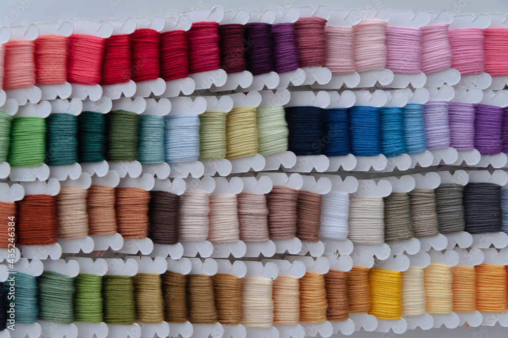 Word DIY world made of colorful bobbins, treads. Do it yourself concept. Sewing, hobby