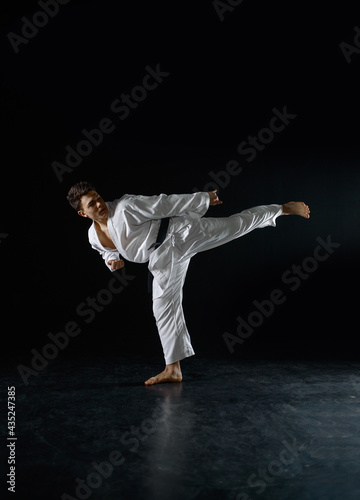 Male karateka, fighter in a combat stance