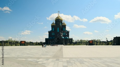 Kubinka, Russia - CIRCA 2021: Orthodox Church or tample in black color with golden domes, general form. smooth camera movement, faith in God and Christ. Cathedral in Park Patriot. photo