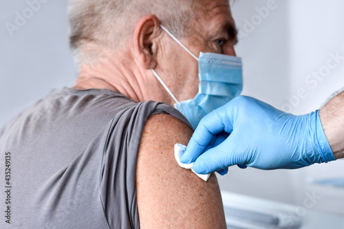 Canvas Print Elderly Man in Face Mask getting Covid Vaccine