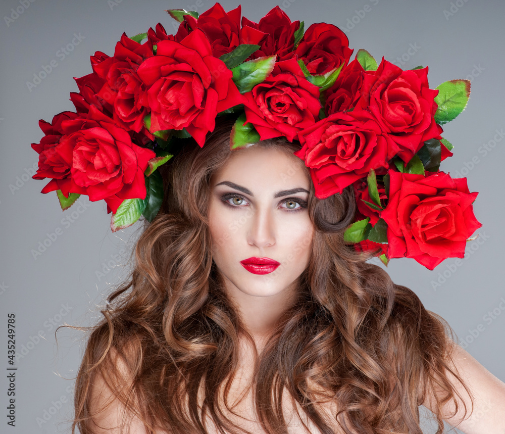 beautiful woman with red roses  Professional makeup. fashion model with large hairstyle and flowers in her hair.