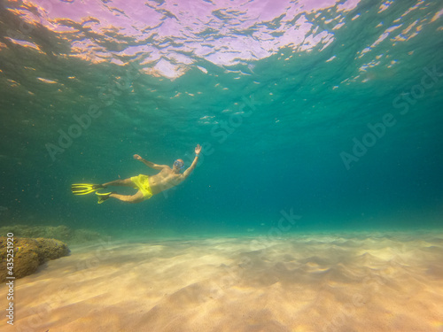 underwater man snorkeling in the sea withcrystal-clear waters concept of holiday relax summer beach diver in the sea 