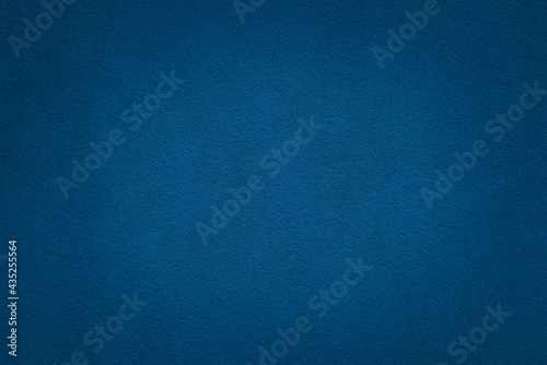 Blue color concrete wall texture background with vignette effect. Finely rough concrete surface.