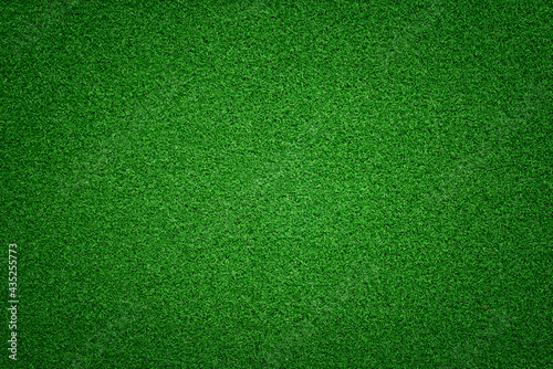 Flat green grass texture with vignette effect. Short grass cutting.