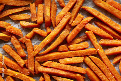 Sweet potato fries on baking parchment paper top view. concept for healthy snacks