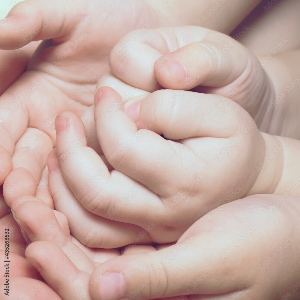 Children's hands close up. New family, Maternal love and baby protection concept Children's hands close up. New family, Maternal love and baby protection concept