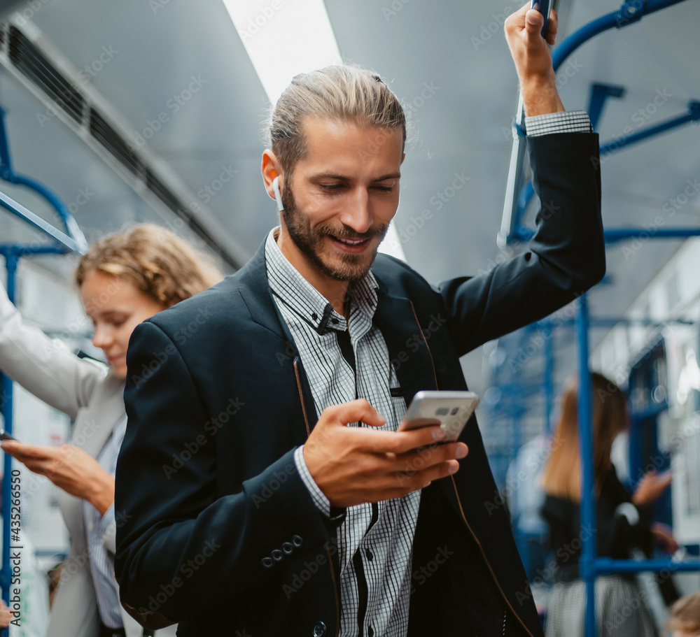 smiling passenger reading a message on his smartphone.