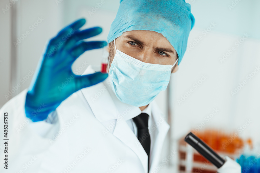 close up. ampoule with a vaccine in the hands of a scientist. close up. ampoule with a vaccine in the hands of a scientist.