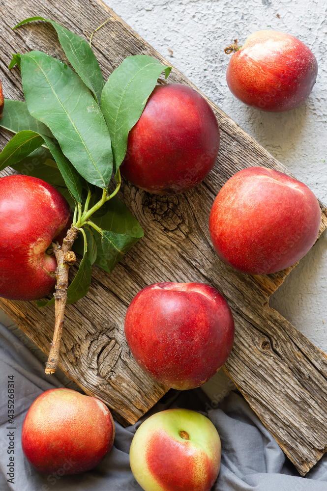 Ripe fresh nectarines on white stone background, healthy organic food, summer fruit Ripe fresh nectarines on white stone background, healthy organic food, summer fruit