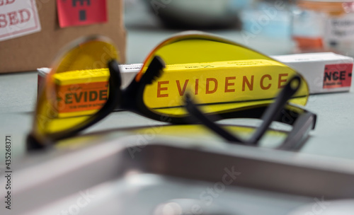 Glasses UV for criminology on police records, conceptual image photo