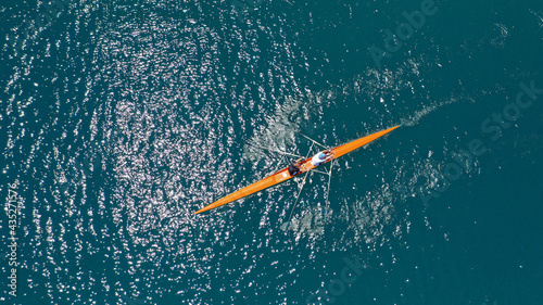 Slika na platnu Aerial drone top down view of sport canoe operated by team of young trained athl