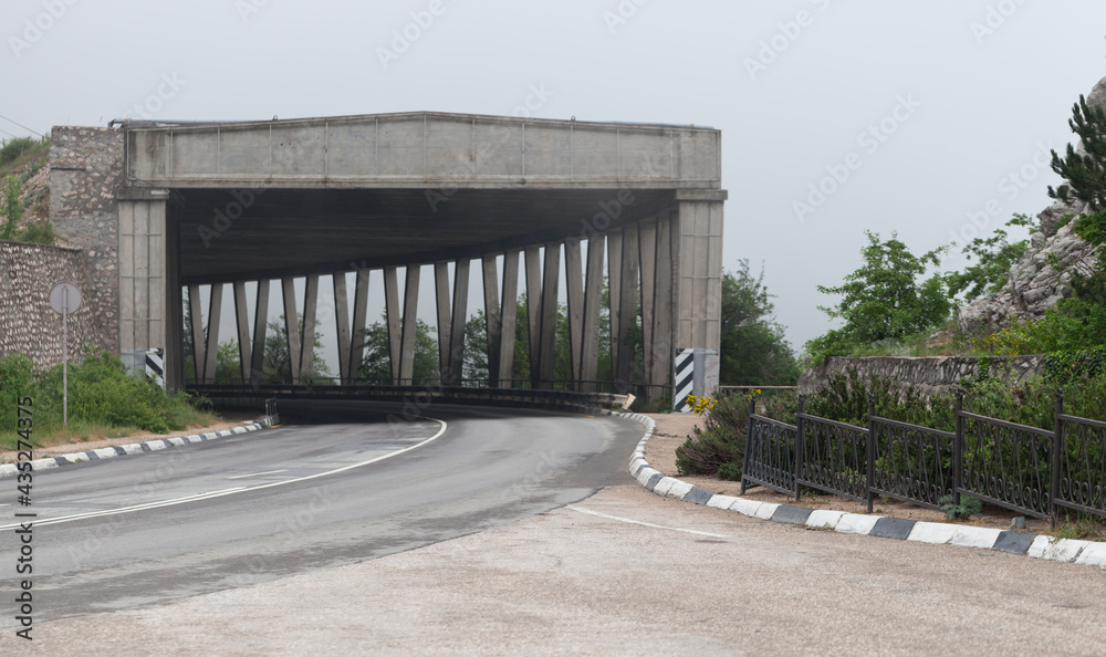 Mountain road with concrete tunnel Mountain road with concrete tunnel