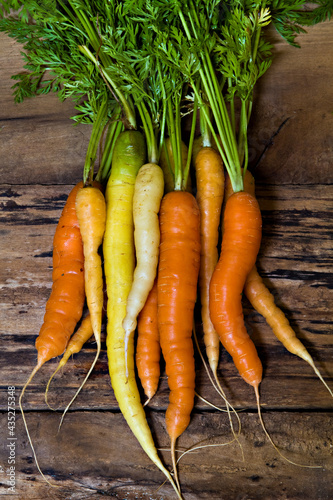 Bunch of carrots on waethered wood  photo