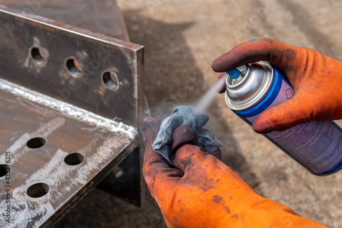 Step to use solvent remover spray into the rag to cleaning the welded surface before performing spray Liquid Penetrant for Non-Destructive Testing(NDT) with process Penetrant Testing(PT). photo