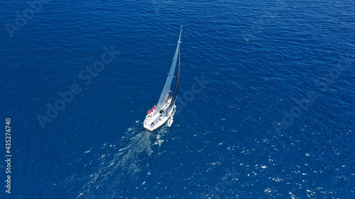 Aerial drone top down photo of beautiful sailing boat cruising in deep blue Atlantic open ocean sea © aerial-drone