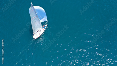 Aerial drone top down photo of beautiful sailing boat cruising in deep blue Atlantic open ocean sea