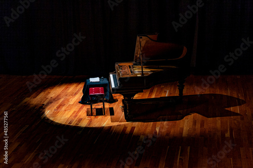 Musical instrument. Beautiful Piano on stage with overhead spot lighting.