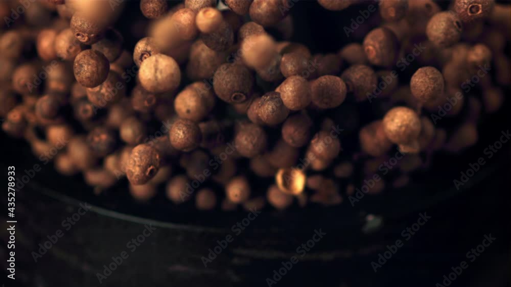 Super slow movement from the mortar fall out of the peas of black pepper. Filmed on a high-speed camera at 1000 fps. Against a dark background. High quality FullHD footage Super slow movement from the mortar fall out of the peas of black pepper. Filmed on a high-speed camera at 1000 fps. Against a dark background. High quality FullHD footage
