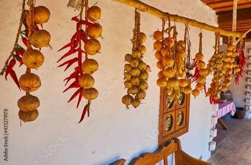 Drying onion and pepper on porch of shynok (medieval Ukrainian restaurant), Mamajeva Sloboda Cossack Village, Kyiv, Ukraine photo