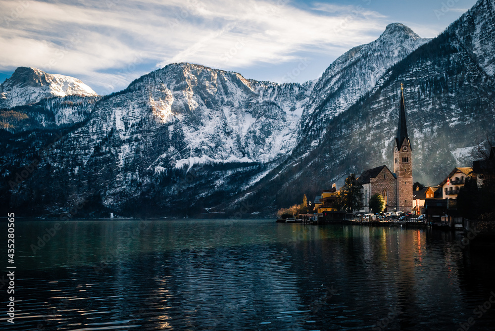 Old church on the lake in a little town at the foot of the mountain 