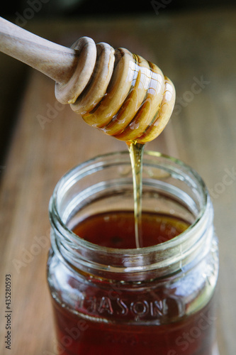 Honey in jar with honey dipper 