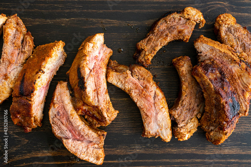 Barbecue Baby Back Ribs on a Wood Table: Pork  back ribs on a dark wood background