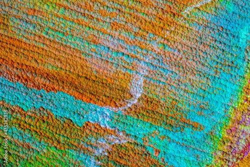 Oxidized copper, abstraction.  Natural orange, blue. green yellow background with patina rusty copper plate