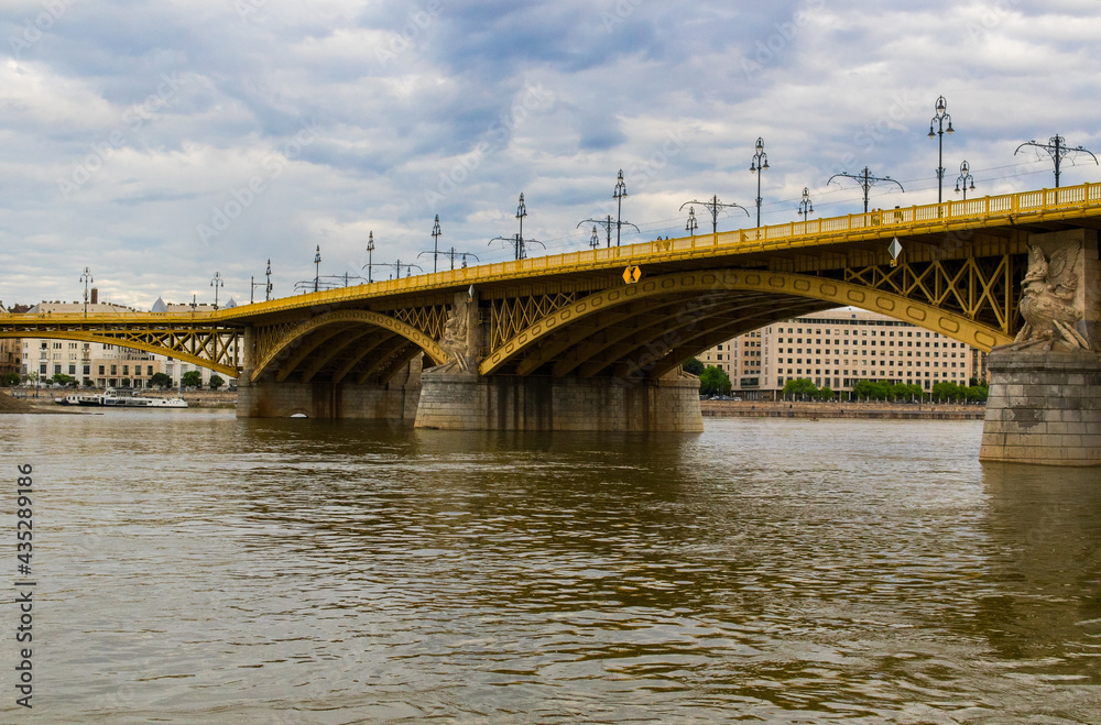 The yellow Margaret Bridge over the Danube River in Budapest, Hungary