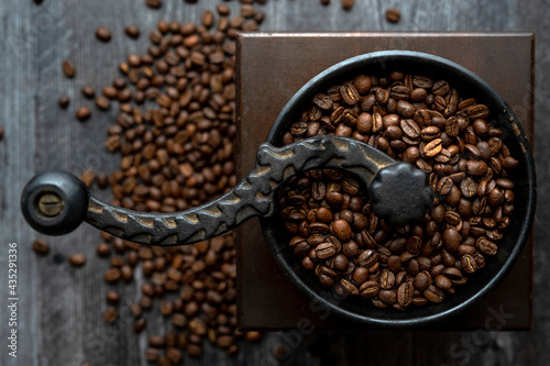 Overhead of coffee beans in hand grinder