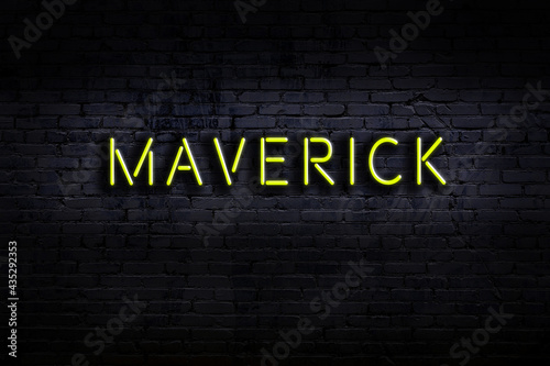 Neon sign. Word maverick against brick wall. Night view photo