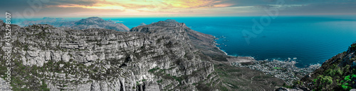 Table mountain from the top, looking out towards the Southern coastline with enhanced sunset sky - Great outdoors adventure and  travel holiday destination, Cape Town, South Africa
