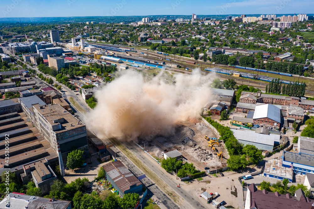 Aerial view of dust cloud after collapsing of old building after demolishing in Kharkiv - obrazy, fototapety, plakaty 