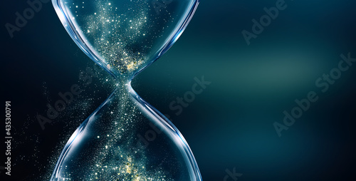 Photos Glass hourglass with glowing sand