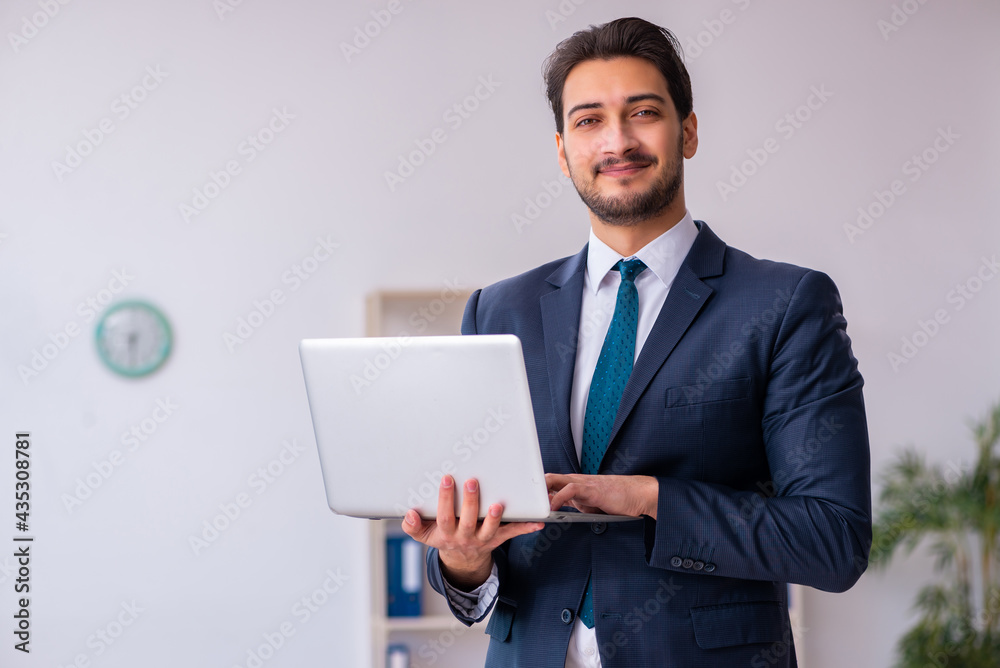 Young handsome businessman employee working in the office Young handsome businessman employee working in the office
