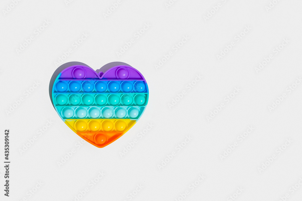 Fototapeta premium Antistress pop it toy. Rainbow sensory fidget isolated on white background. New trendy silicone toy.
