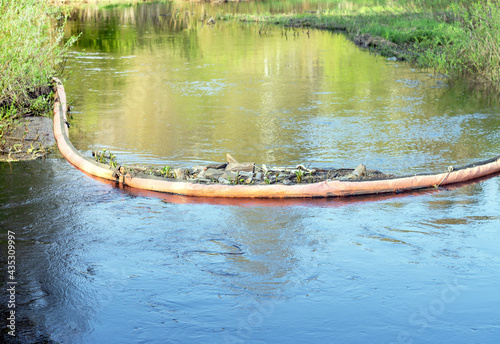 The floating barrier collects river waste to trap plastic bags, bottles, and other waste.