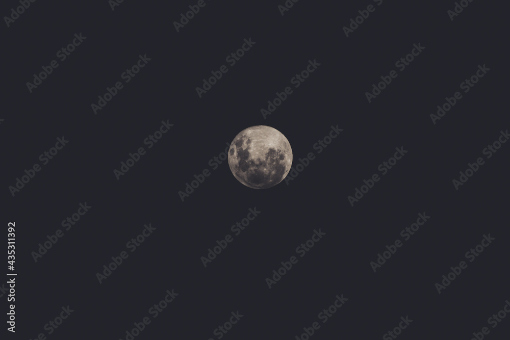 full moon in the night sky shot with telephoto lens full moon in the night sky shot with telephoto lens